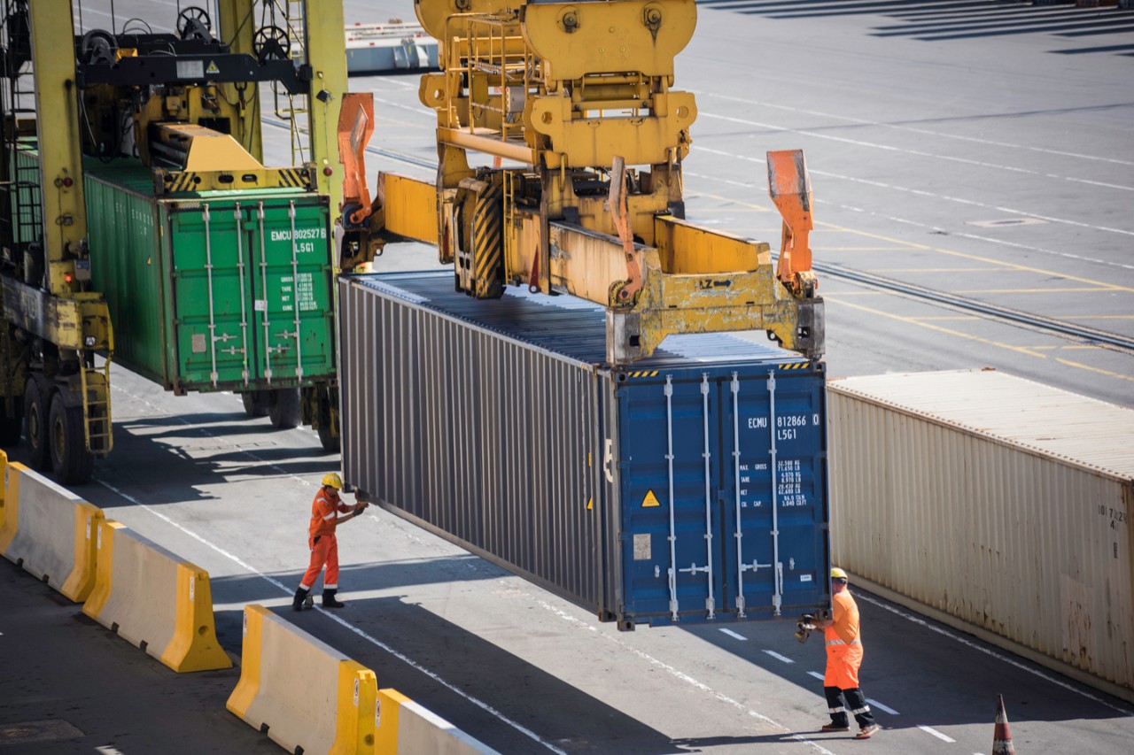 Dockers locked a container elevated on container ship