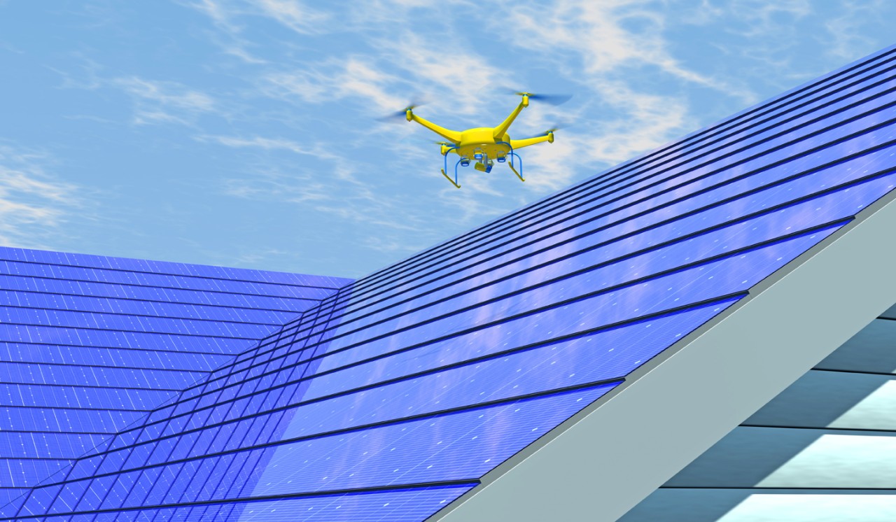 Computer generated render of UAV drone inspecting an integrated solar shingle roof. Fictitious UAV and generic solar panels; lens flare, depth-of-field and motion blur for dramatic effect.